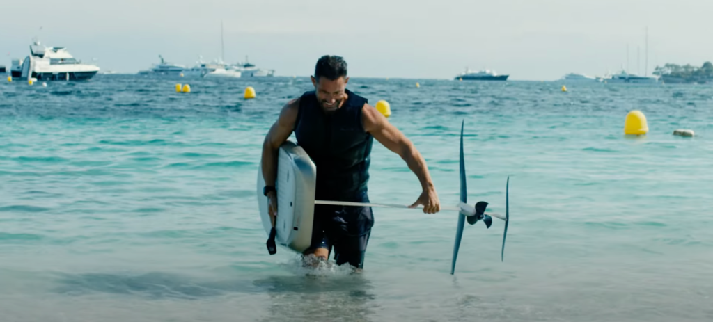 man carrying fliteboard out of water