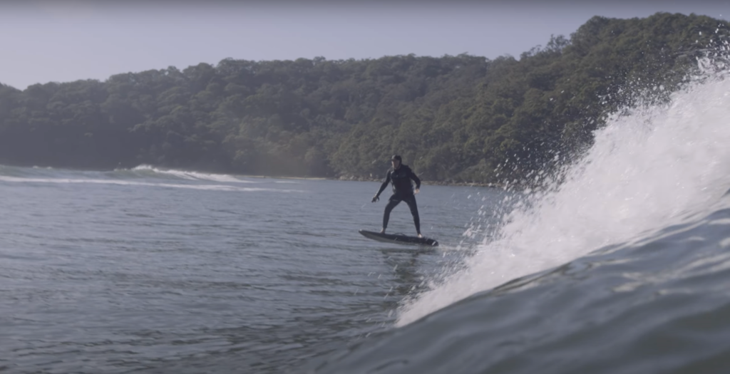 person riding a fliteboard wearing a wetsuit