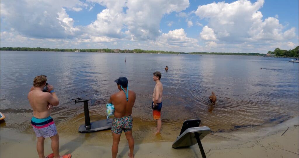 men on beach with efoils