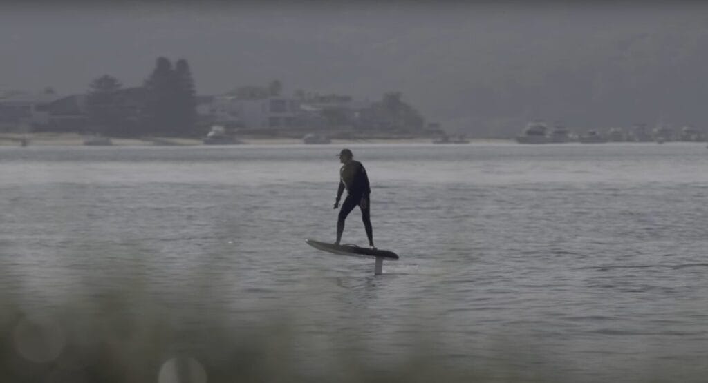 riding an efoil in a wetsuit