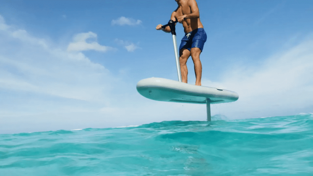 Rider using a FliteScooter with a short eFoil mast on open water