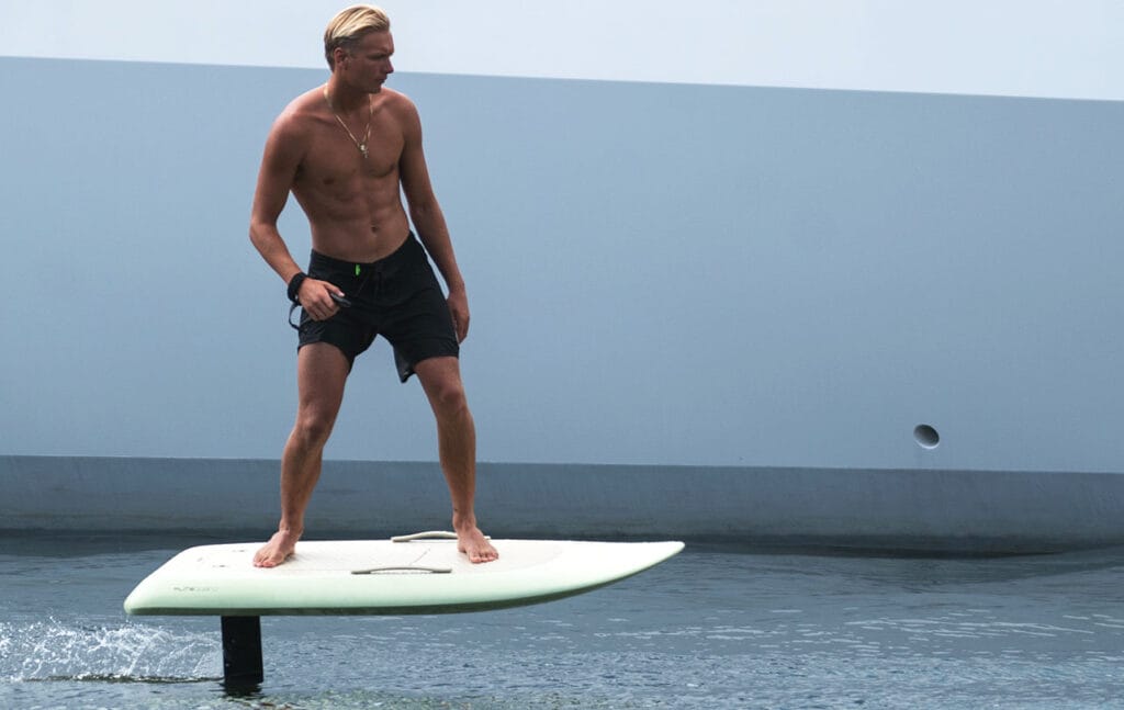 Fliteboard rider on an eFoil showing mast height above the water